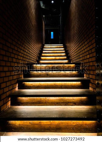 modern stair with yellow light and bricks wall