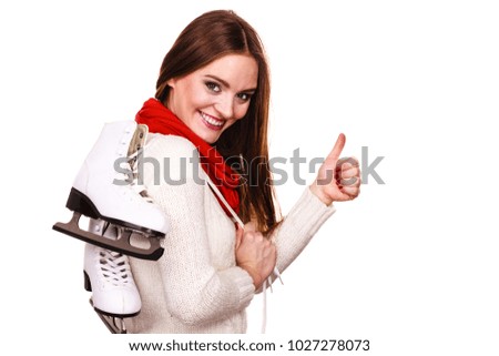 Woman with ice skates getting ready for ice skating, winter sport activity. Smiling cheerful girl wearing warm clothing on white