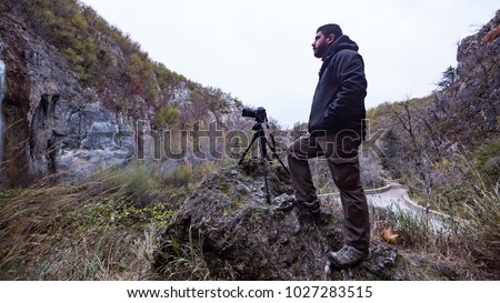 Professional photographer taking picture inside the Plitvice Lakes National Park. Croatia. Europe.