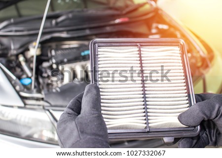 Hand a man change and check air filter of car in the engine room Royalty-Free Stock Photo #1027332067