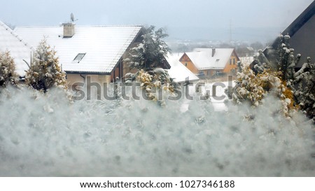 View of houses from snowy window