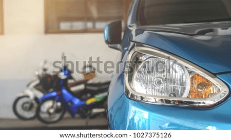Close up view of shiny blue color city car headlight.