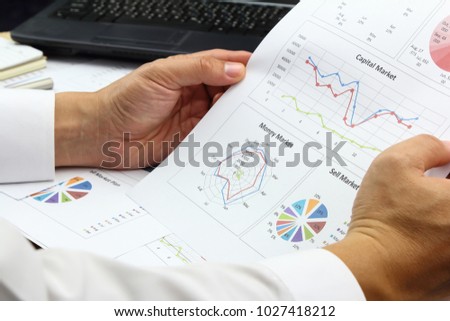Businessman Summary report and money market plan analyzing sell market plan,and Review accounting data and calculate order income.