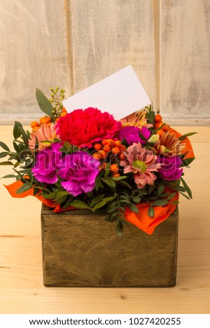 Image of fresh spring flowers with copy space. Bouquet of flowers with a white card.