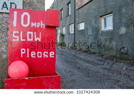 Red Custom Painted Warning Road Sign Asking Drivers To Slow Down