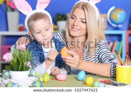 Mother and son paint Easter eggs