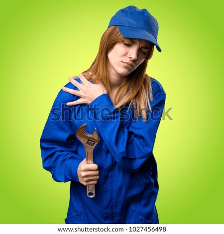 Delivery woman with shoulder pain on colorful background