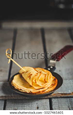 Pancakes (crepes) on a wooden surface