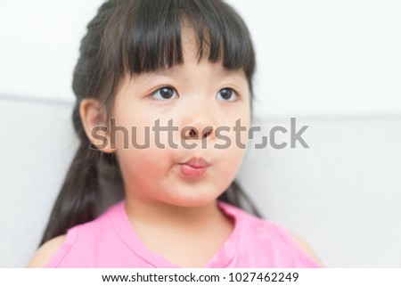 Child asian girl watching TV on sofa bed in living room.Asian child.Child development.