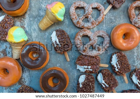 Various of arififcal food such as ice creams, donuts and sandwiches on vintage background