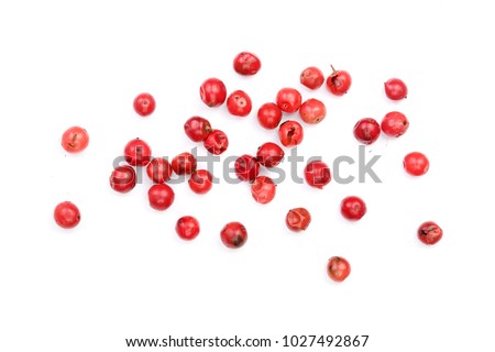 pink peppercorns seeds isolated on white background. Top view. Flat lay Royalty-Free Stock Photo #1027492867