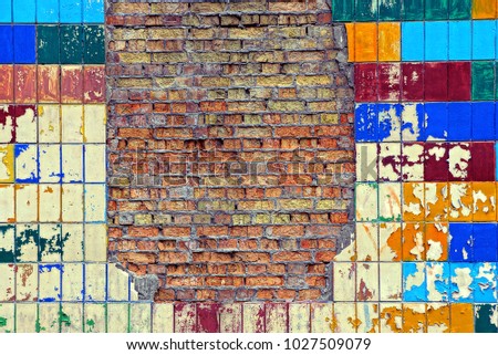 Bright texture of a brick wall and a colored tile