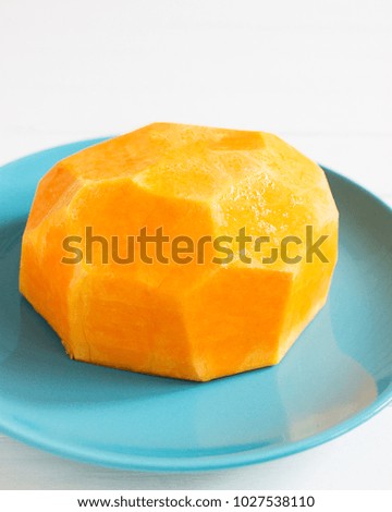 Geometric orange pumpkin blue plate vegetarian food.