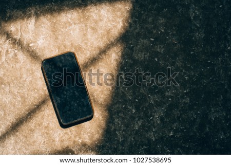Old smartphone on concrete wall background,copy space.