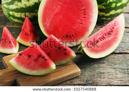 Slices of watermelons on cutting board Royalty-Free Stock Photo #1027540888