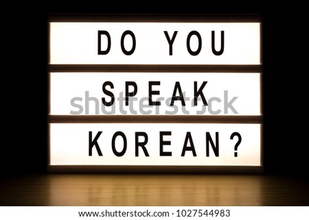 Do you speak Korean light box sign board on wooden table. 