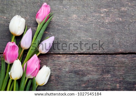 Bouquet of tulips on grey wooden table