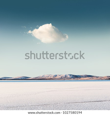 Cloud over a frozen lake. Beautiful winter landscape
