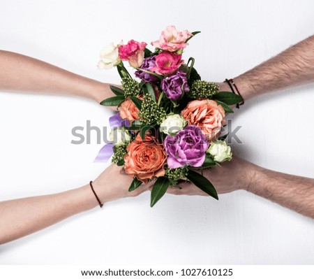 Man hands, flowers, white background, woman hands
