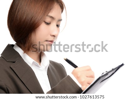 Young Asian Women wear suit holding clipboard and writing by pen isolated on white background