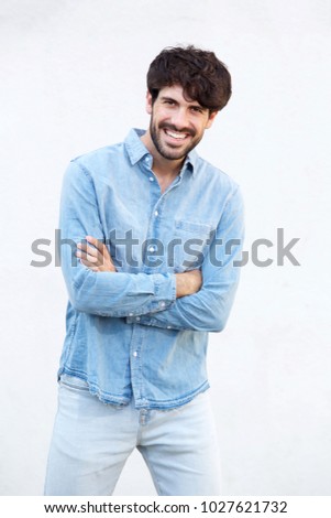 Portrait of happy smiling man posing against white background