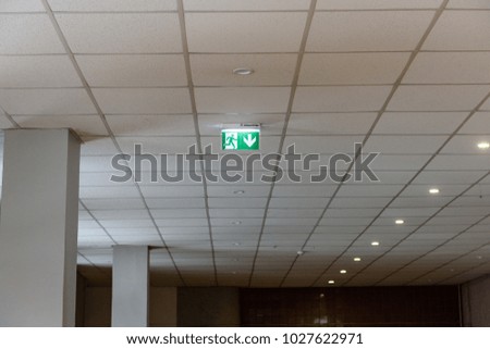 interior elements in large hall. green exit sign on the sealing