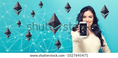 Ethereum with young woman holding out a smartphone in her hand