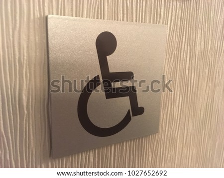 Handicapped Sign on Hotel Wall - handicapped accessible space, accommodations for disabled