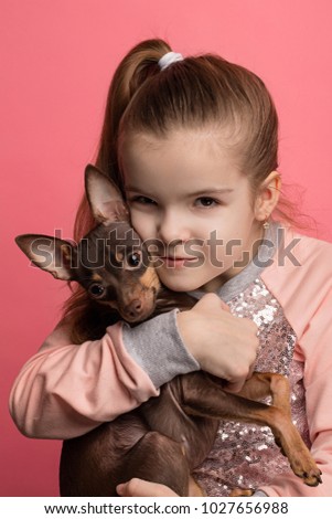 Beautiful young girl with cute terrier dog