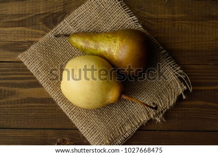 resh organic fruits. Natural pears with leaves onto a vintage wooden background. Natural fruit concept. Food background. Healthy food from garden. Rustic style