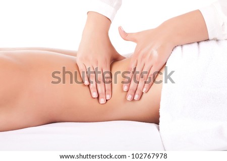 Beautiful young woman receiving a massage Royalty-Free Stock Photo #102767978