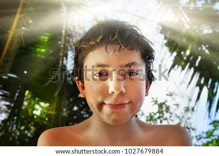 boy lovely beach portrai with palms sun sky on the background