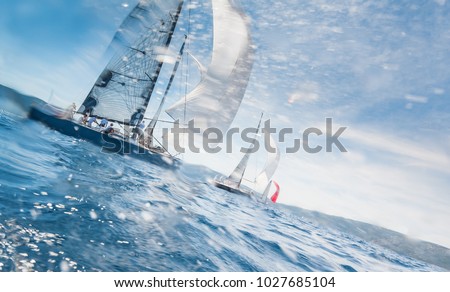 Sailing boats with spinnakers racing on open sea, water drift is motion blured Royalty-Free Stock Photo #1027685104