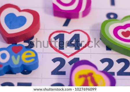 14th February marked with a heart on calendar and wooden pins with red hearts. Close up. St.Valentine's concept.