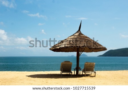 chaise longue beach umbrella on the beach by the sea