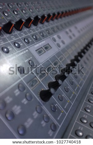 Sound mastering table with many buttons, sliders and leds