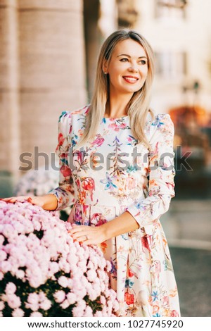 Outdoor portrait of young blond woman wearing beautiful dress. Image taken in Vevey, Switzerland