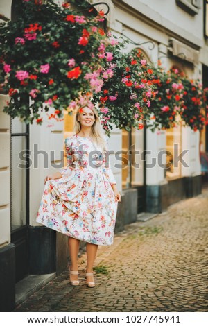 Outdoor portrait of young blond woman wearing beautiful dress. Image taken in Vevey, Switzerland