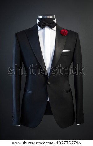 Tailored suit, tuxedo isolated on black background on mannequin Royalty-Free Stock Photo #1027752796
