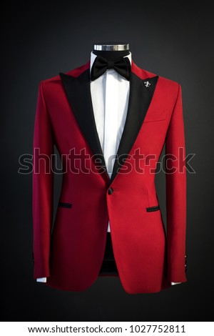 Red tailored suit, tuxedo isolated on black background on mannequin Royalty-Free Stock Photo #1027752811