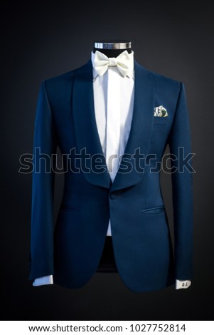 Tailored suit, tuxedo isolated on black background on mannequin Royalty-Free Stock Photo #1027752814