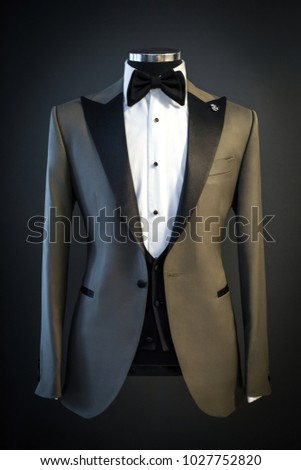 Tailored suit, tuxedo isolated on black background on mannequin Royalty-Free Stock Photo #1027752820