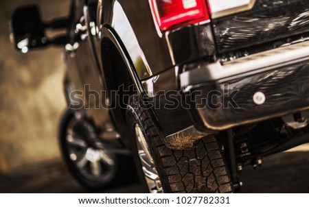 Modern Pickup Truck Shallow Depth of Field Photo. Vehicle Rear. Focusing on the Tire. Royalty-Free Stock Photo #1027782331
