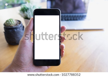 Man's hands holding mobile phone with blank white screen can be add your texts or others, copy space for advertising, product display. Royalty-Free Stock Photo #1027788352