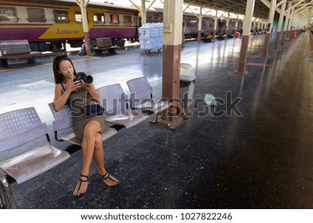 Portrait of young beautiful multi-ethnic tourist woman exploring the city of Bangkok, Thailand