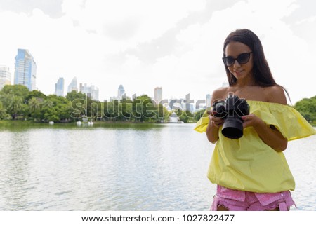 Portrait of young beautiful multi-ethnic tourist woman exploring the city of Bangkok, Thailand