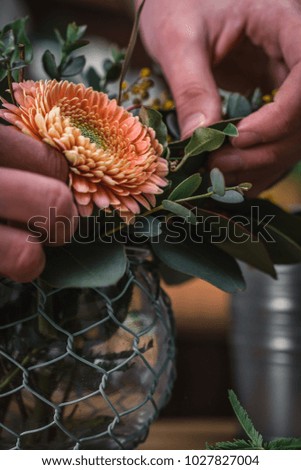Florist making beautiful bouquet at flower shop