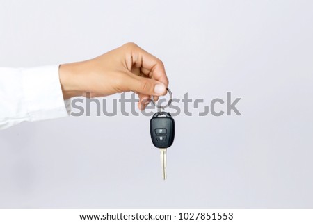 Businessman holding the  car key, isolated background