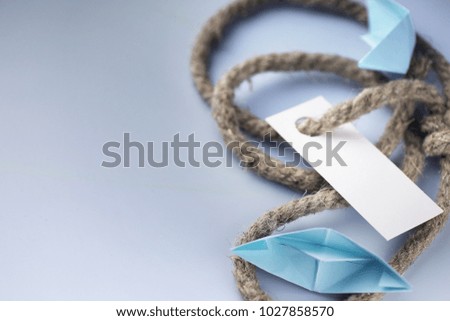 white sticker with thick braided rope and ship paper origami