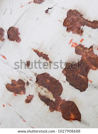 Pattern of old painted metal surface. Rusty metal, peeling paint, Brown tones, bright colors.